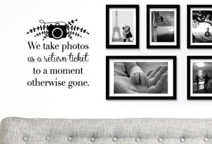 This vinyl sticker, wall art of a camera and the saying, "We take photos as a return ticket to a moment otherwise gone"